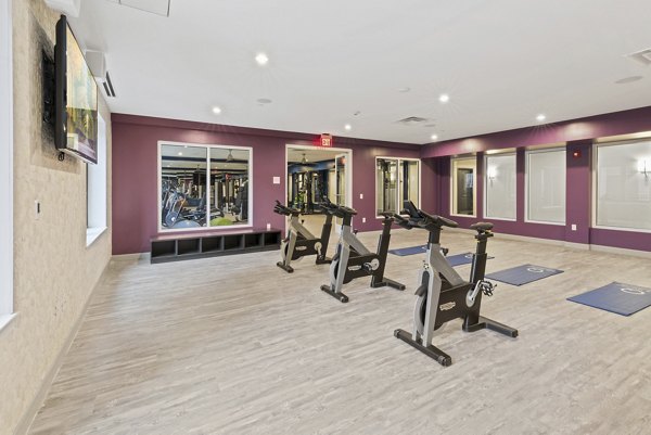 Fitness room featuring state-of-the-art equipment at The Quincy Apartments