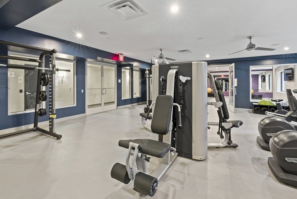 Fitness room with modern equipment at The Quincy Apartments