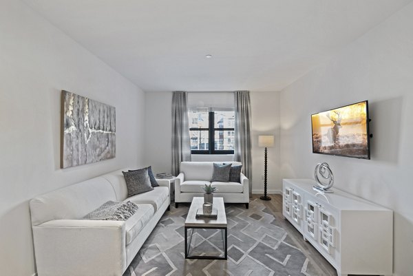 Spacious living room with modern furnishings at The Quincy Apartments