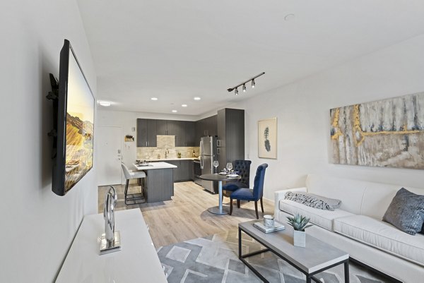 Spacious living room featuring modern design elements in The Quincy Apartments
