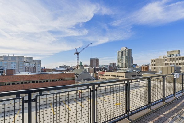 Cityscape view with a construction crane and clear blue sky, featuring buildings in the background
