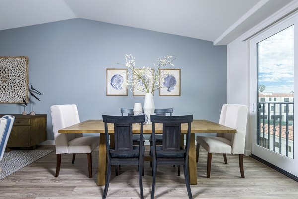 Dining room with elegant seating and ocean views at Portside Ventura Harbor Apartments
