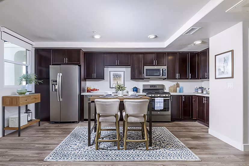 Dining room with modern decor at Portside Ventura Harbor Apartments featuring elegant lighting and waterfront views