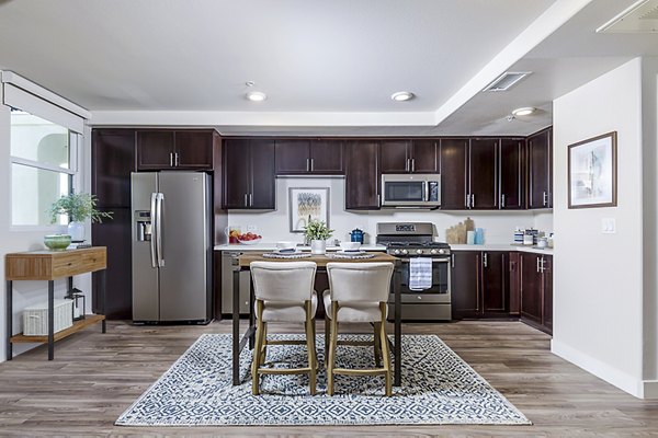 Dining room with modern decor at Portside Ventura Harbor Apartments featuring elegant lighting and waterfront views