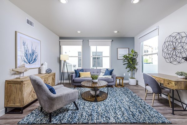 Spacious living room with coastal decor at Portside Ventura Harbor Apartments