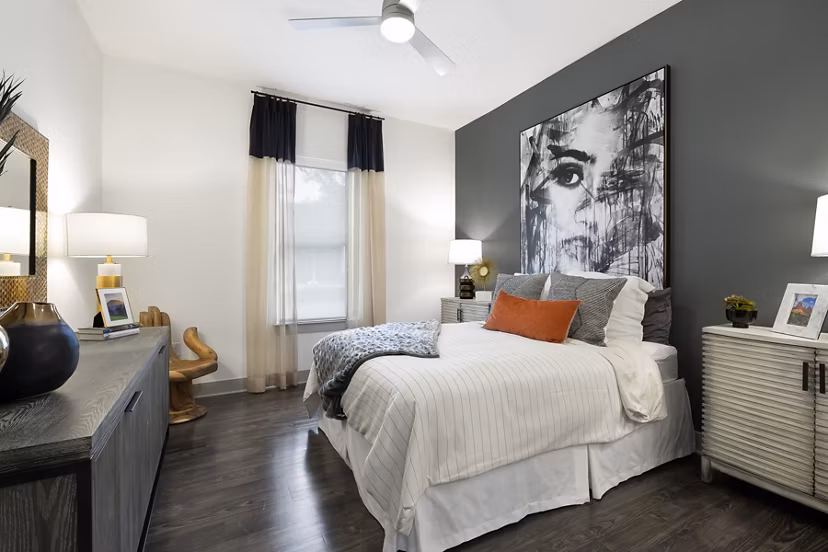 Cozy bedroom with modern decor at Atlas Waterside Apartments, featuring natural light and plush bedding