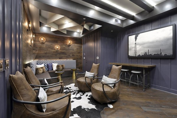 Clubhouse lounge with modern seating and entertainment at Atlas Waterside Apartments