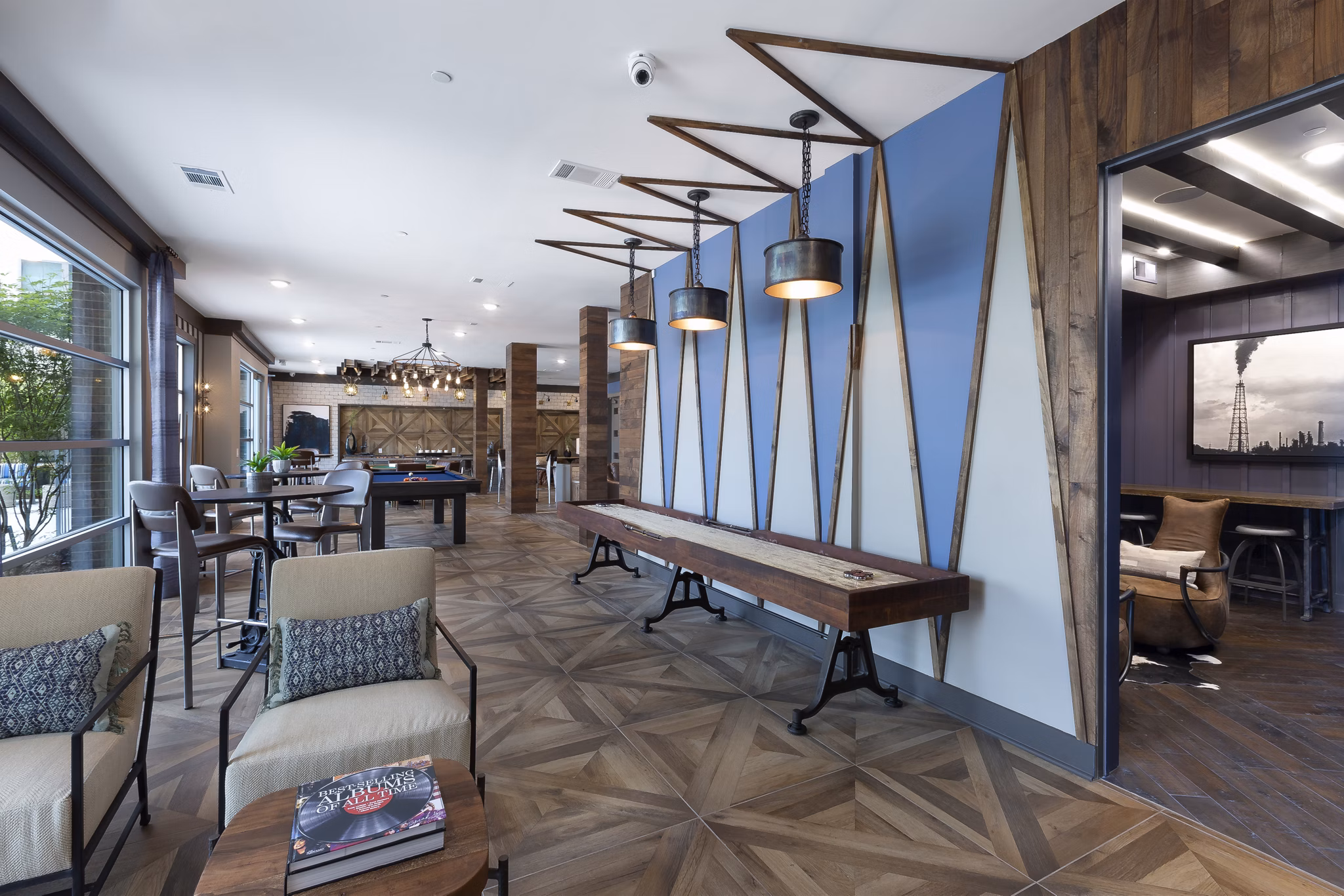 Game room with billiards and lounge seating at Atlas Waterside Apartments, offering a luxury experience