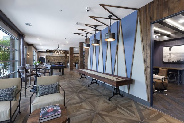 Game room with billiards and lounge seating at Atlas Waterside Apartments, offering a luxury experience