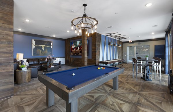 Game room with billiards and seating area at Atlas Waterside Apartments, offering entertainment and relaxation for residents