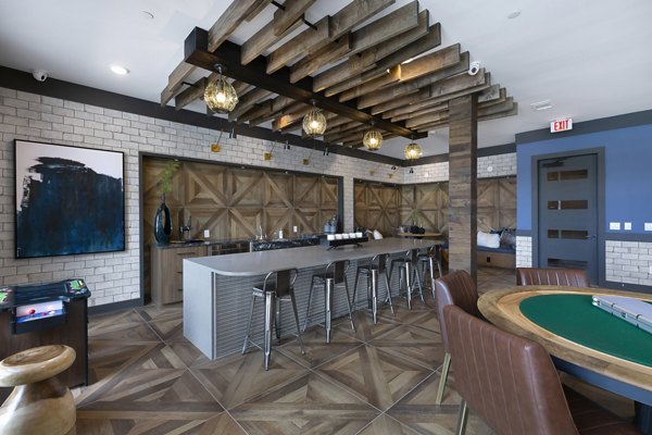 Game room featuring pool tables and lounge seating in Atlas Waterside Apartments for recreation and socializing