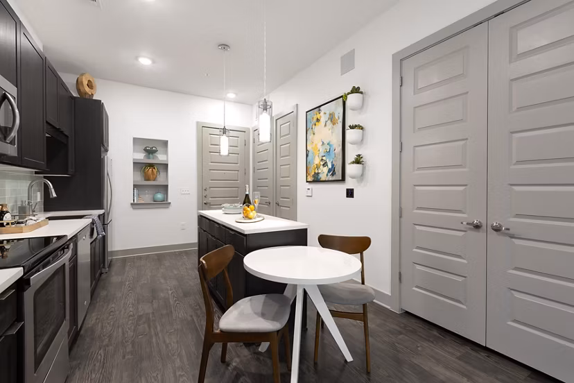 Dining area featuring modern furnishings and natural lighting in Atlas Waterside Apartments