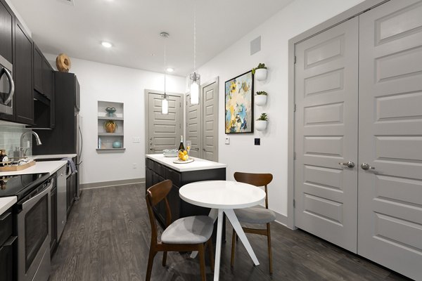 Dining area featuring modern furnishings and natural lighting in Atlas Waterside Apartments