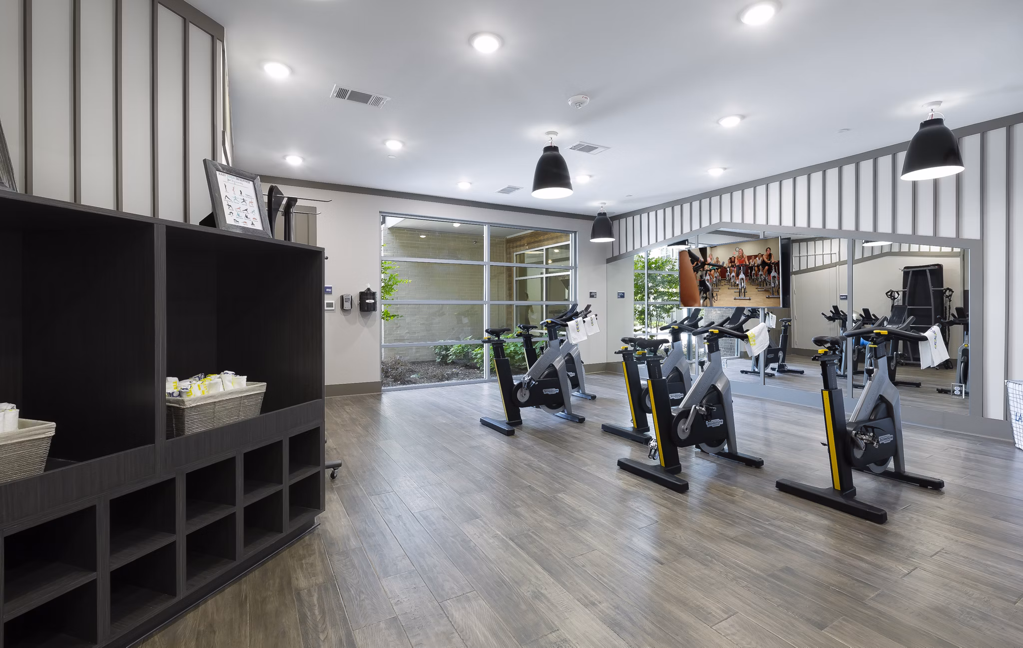 Yoga/spin studio with modern equipment at Atlas Waterside Apartments, ideal for fitness enthusiasts seeking luxury living