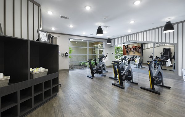 Yoga/spin studio with modern equipment at Atlas Waterside Apartments, ideal for fitness enthusiasts seeking luxury living