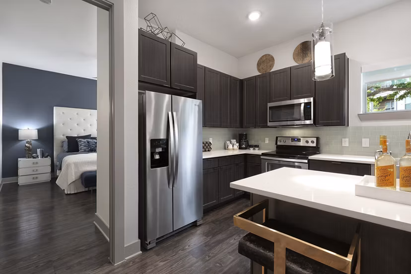 Modern kitchen with stainless steel appliances at Atlas Waterside Apartments