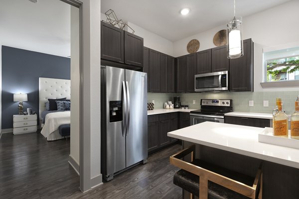 Modern kitchen with stainless steel appliances at Atlas Waterside Apartments
