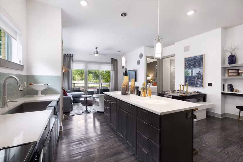 Modern kitchen featuring stainless steel appliances and quartz countertops at Atlas Waterside Apartments