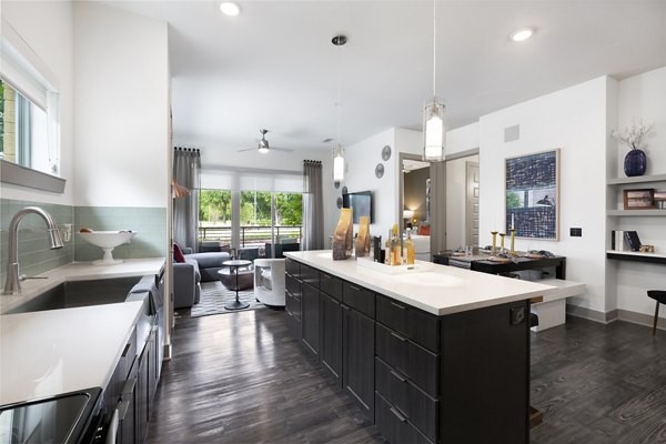 Modern kitchen featuring stainless steel appliances and quartz countertops at Atlas Waterside Apartments