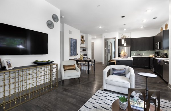Atlas Waterside Apartments: Modern living room with sleek furnishings and large windows