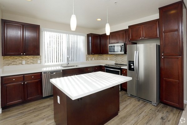 Modern kitchen with stainless steel appliances and marble countertops in Tamarind Square luxury apartments