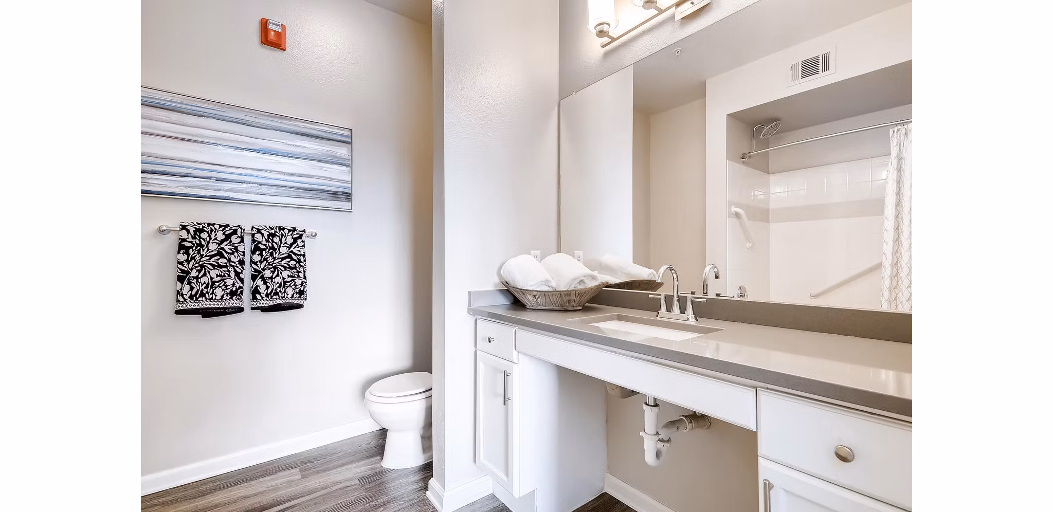 Modern bathroom with sleek fixtures and ample storage at Lowry Park Apartments