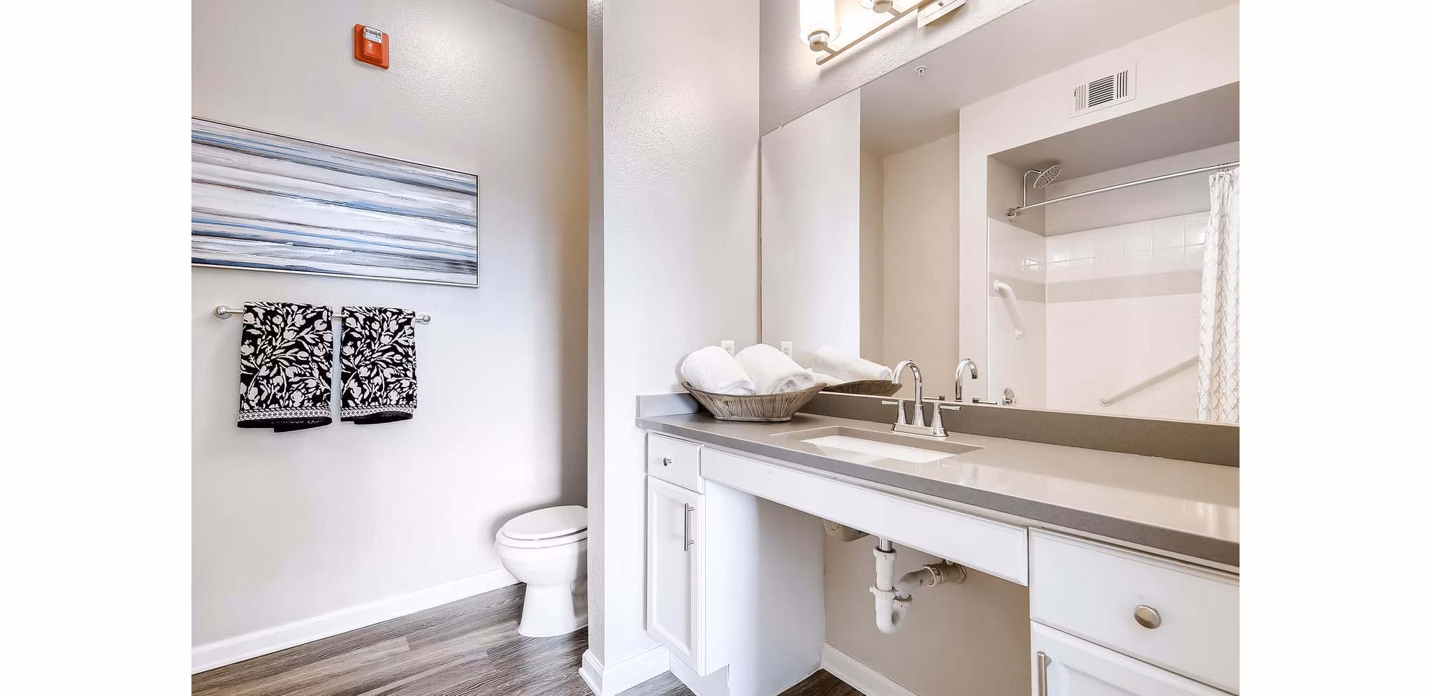 Modern bathroom with sleek fixtures and ample storage at Lowry Park Apartments
