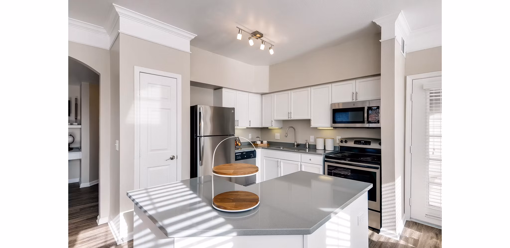Modern kitchen with stainless steel appliances and white cabinetry in Lowry Park Apartments