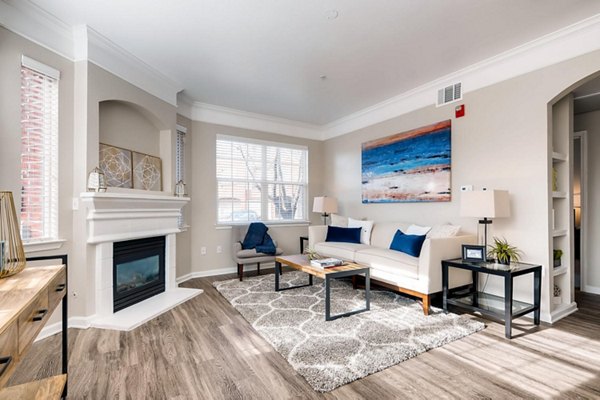 Cozy living room with modern decor at Lowry Park Apartments, featuring comfortable seating and natural light
