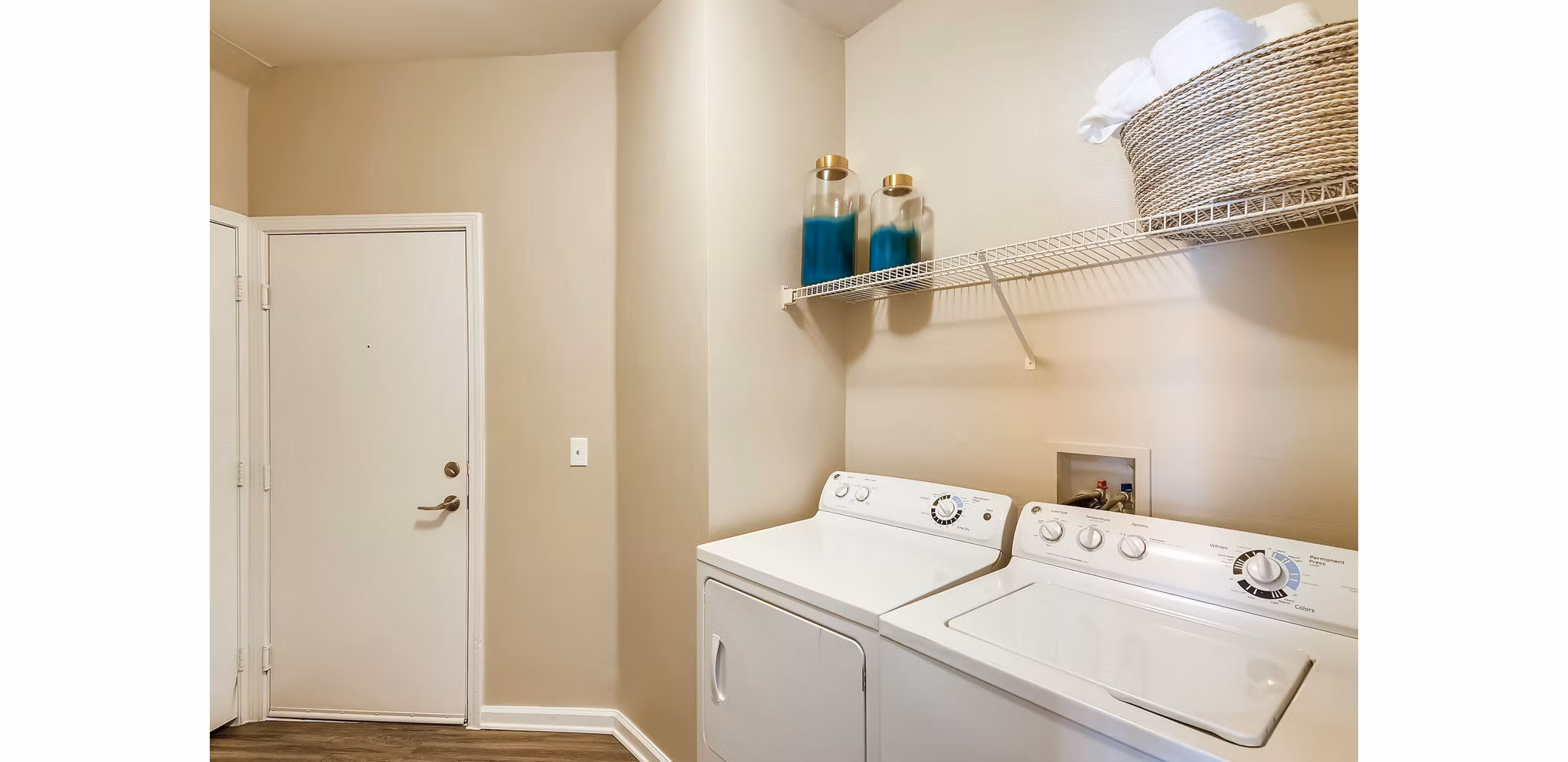 Laundry room featuring modern appliances at Lowry Park Apartments, luxury living by Greystar