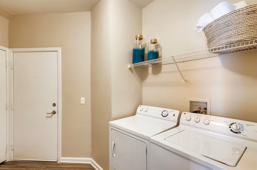 Laundry room featuring modern appliances at Lowry Park Apartments, luxury living by Greystar