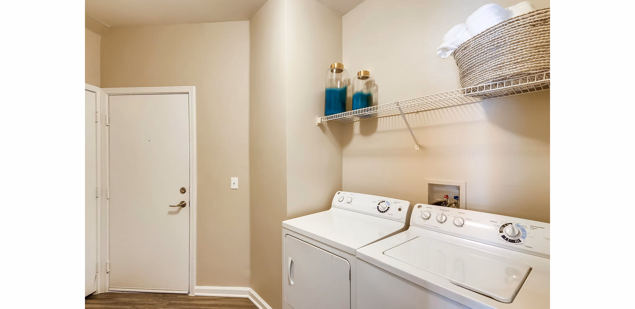 Laundry room featuring modern appliances at Lowry Park Apartments, luxury living by Greystar