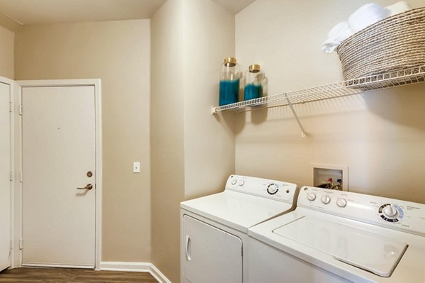 Laundry room featuring modern appliances at Lowry Park Apartments, luxury living by Greystar