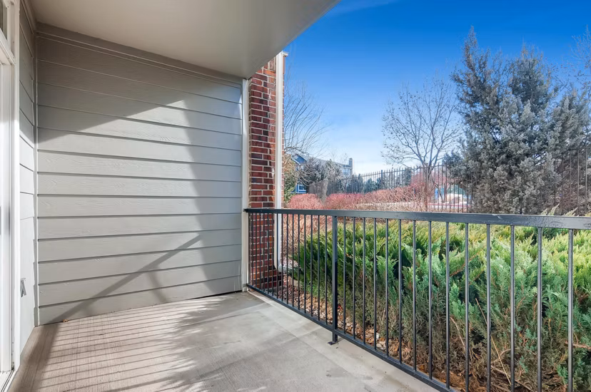 Modern patio with lounge chairs and greenery at Lowry Park Apartments, perfect for relaxation and socializing outdoors