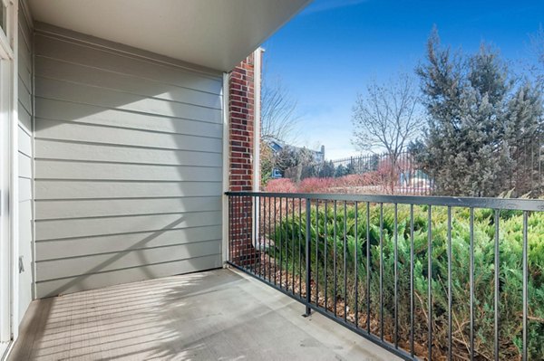 Modern patio with lounge chairs and greenery at Lowry Park Apartments, perfect for relaxation and socializing outdoors