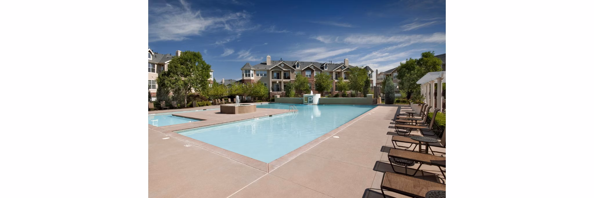 Poolside relaxation area at Lowry Park Apartments featuring modern luxury seating and poolside views