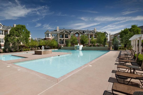 Poolside relaxation area at Lowry Park Apartments featuring modern luxury seating and poolside views