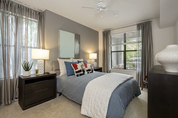 City Place Apartments: Modern bedroom with stylish decor and large windows