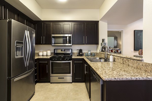 Modern kitchen with stainless steel appliances at City Place Apartments, offering luxury living spaces and convenient amenities