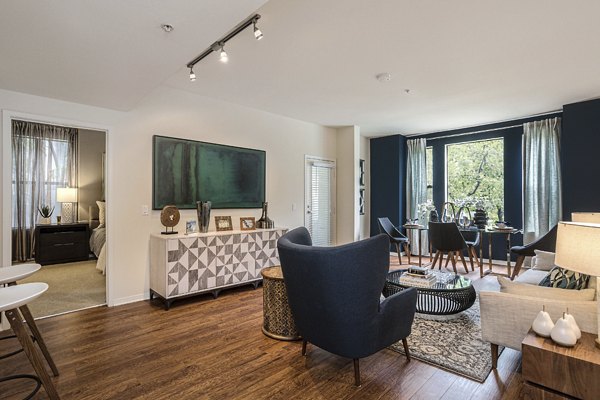 Living room with modern decor and large windows at City Place Apartments