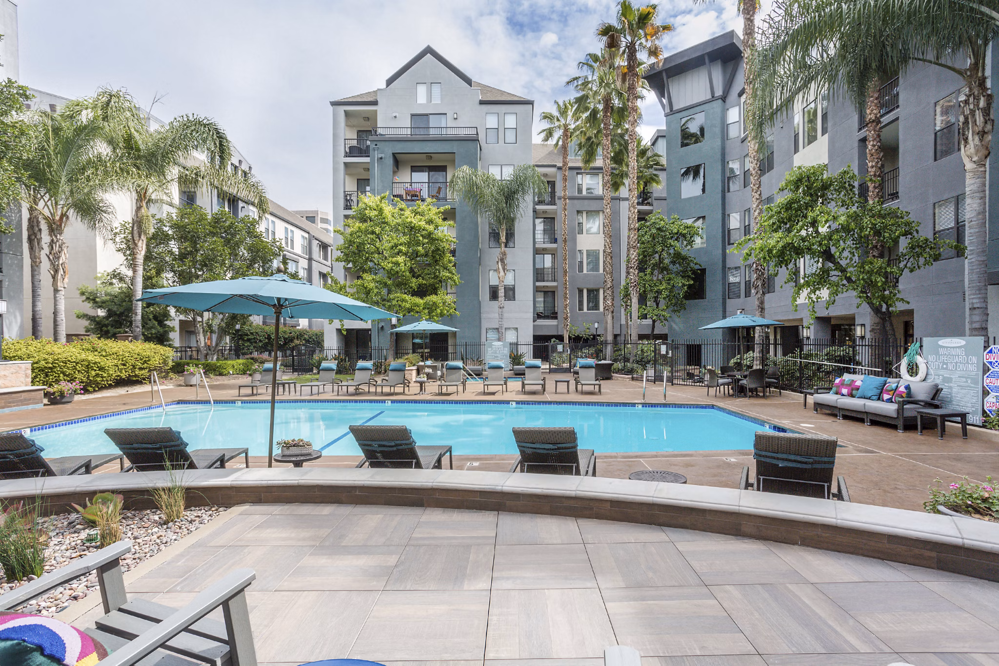 City Place Apartments: Modern pool with sun deck for residents' relaxation