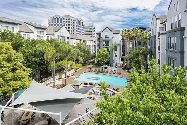 Resort-style pool with lounge chairs at City Place Apartments, a luxury property by Greystar