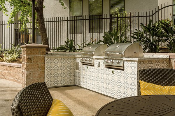 Outdoor grill area at City Place Apartments featuring modern BBQ stations and seating for gatherings