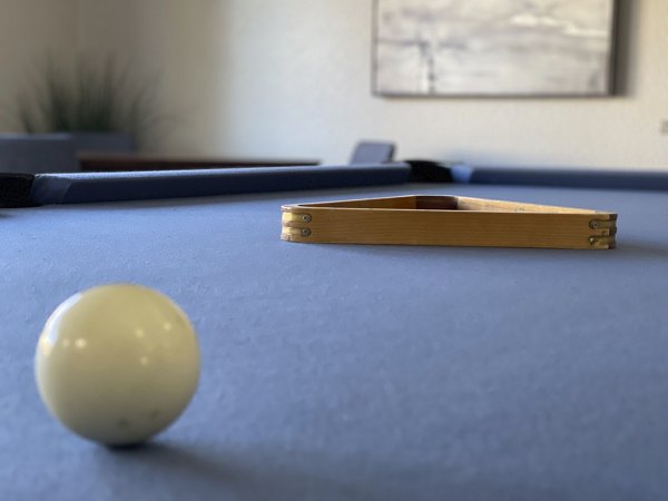 Game room with billiards and gaming consoles at Aspen Ridge Apartments for luxury entertainment