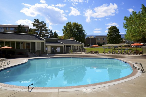 Resort-style pool with lounge chairs at Aspen Ridge Apartments, perfect for relaxation and leisure activities