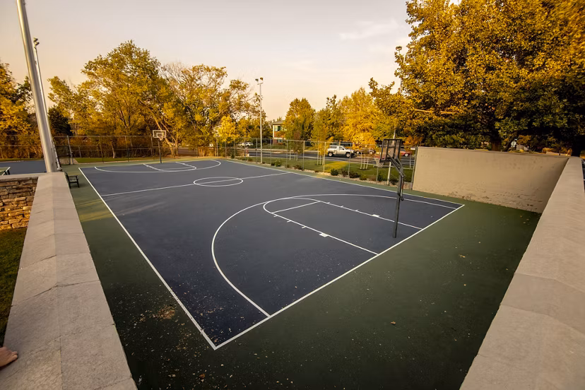 Sport court with basketball hoops at Aspen Ridge Apartments