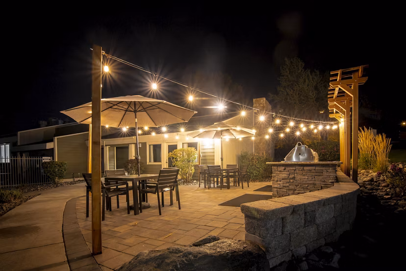 Outdoor grill area with modern seating at Aspen Ridge Apartments, ideal for gatherings and relaxation
