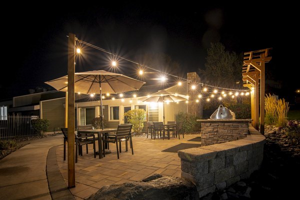 Outdoor grill area with modern seating at Aspen Ridge Apartments, ideal for gatherings and relaxation