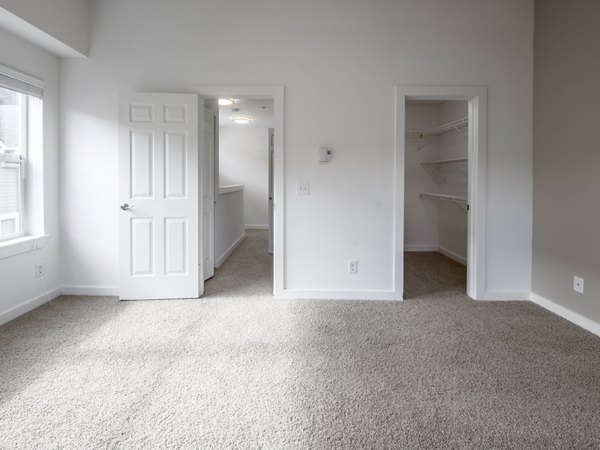 Bedroom with modern decor and plush bedding at Lions Gate North Apartments