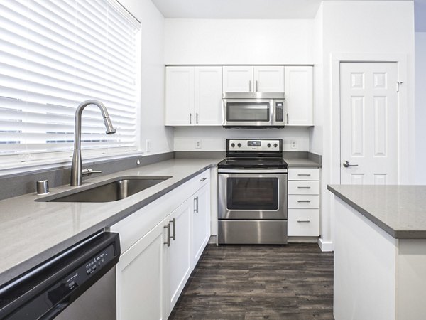 Modern kitchen with stainless steel appliances at Lions Gate North Apartments